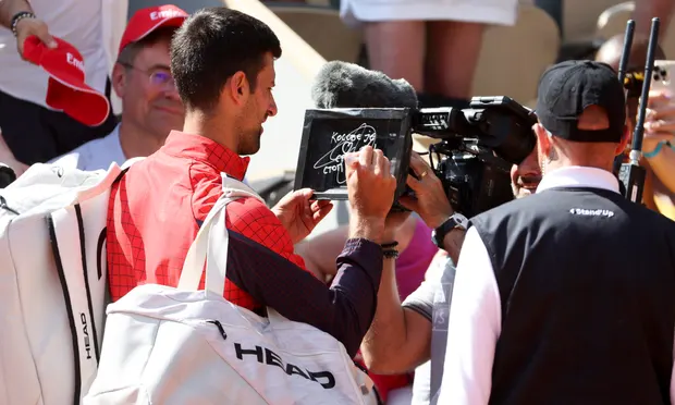 Novak Djokovic wrote on the camera lens: 'Kosovo is the heart of Serbia. Stop the violence'. Photograph: Jean Catuffe/Getty Images
